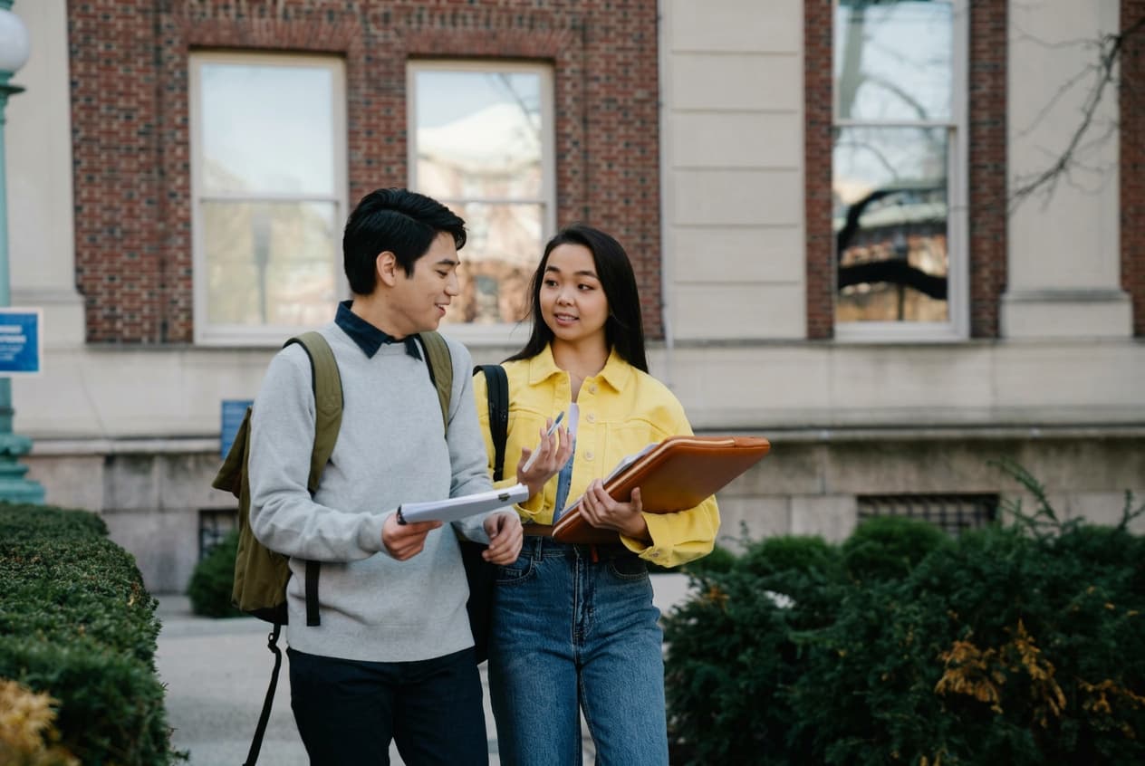 Students walking through a UK summer programme campus.
