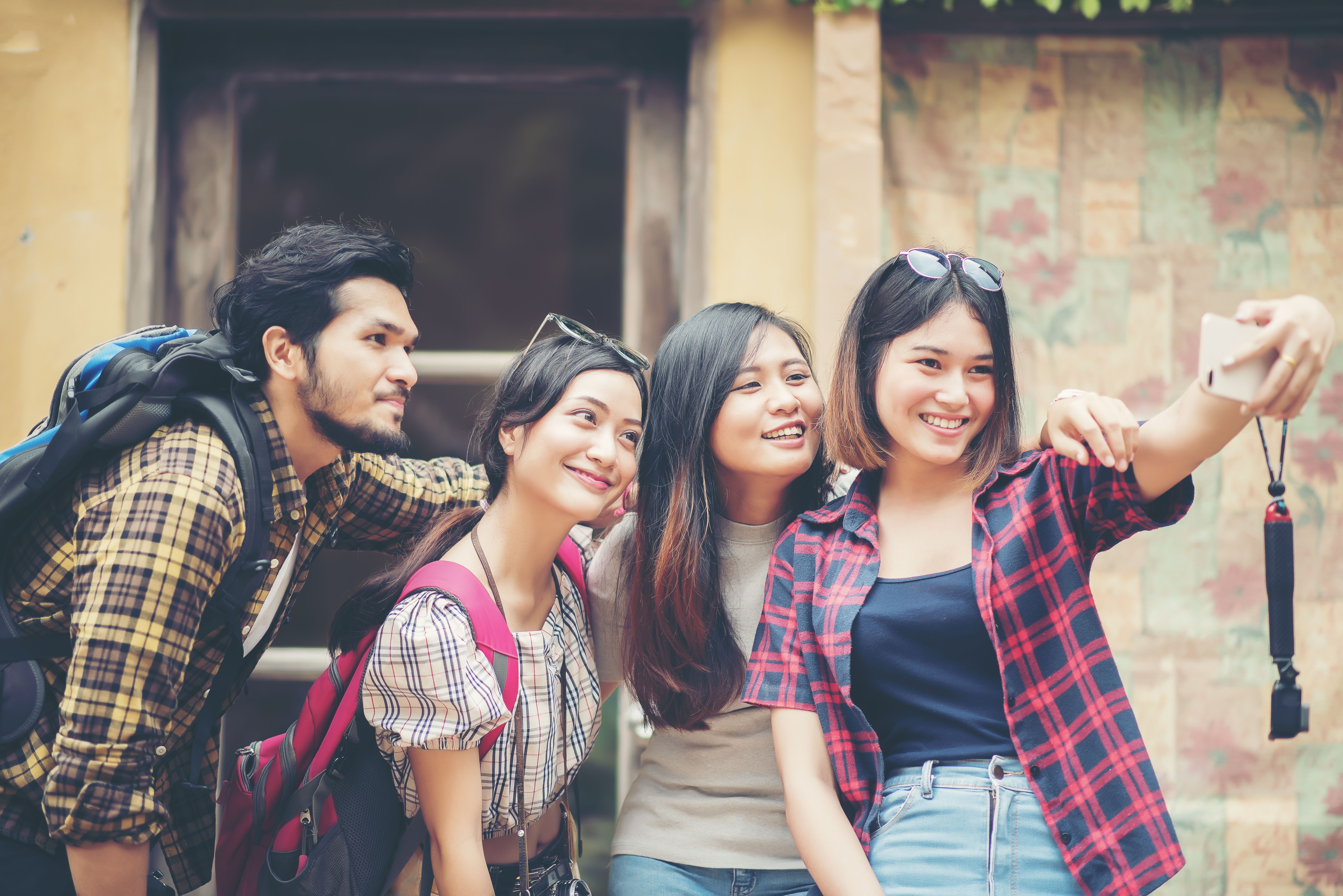 Planning study abroad from Singapore — Group friends taking selfie urban street having good fun together.