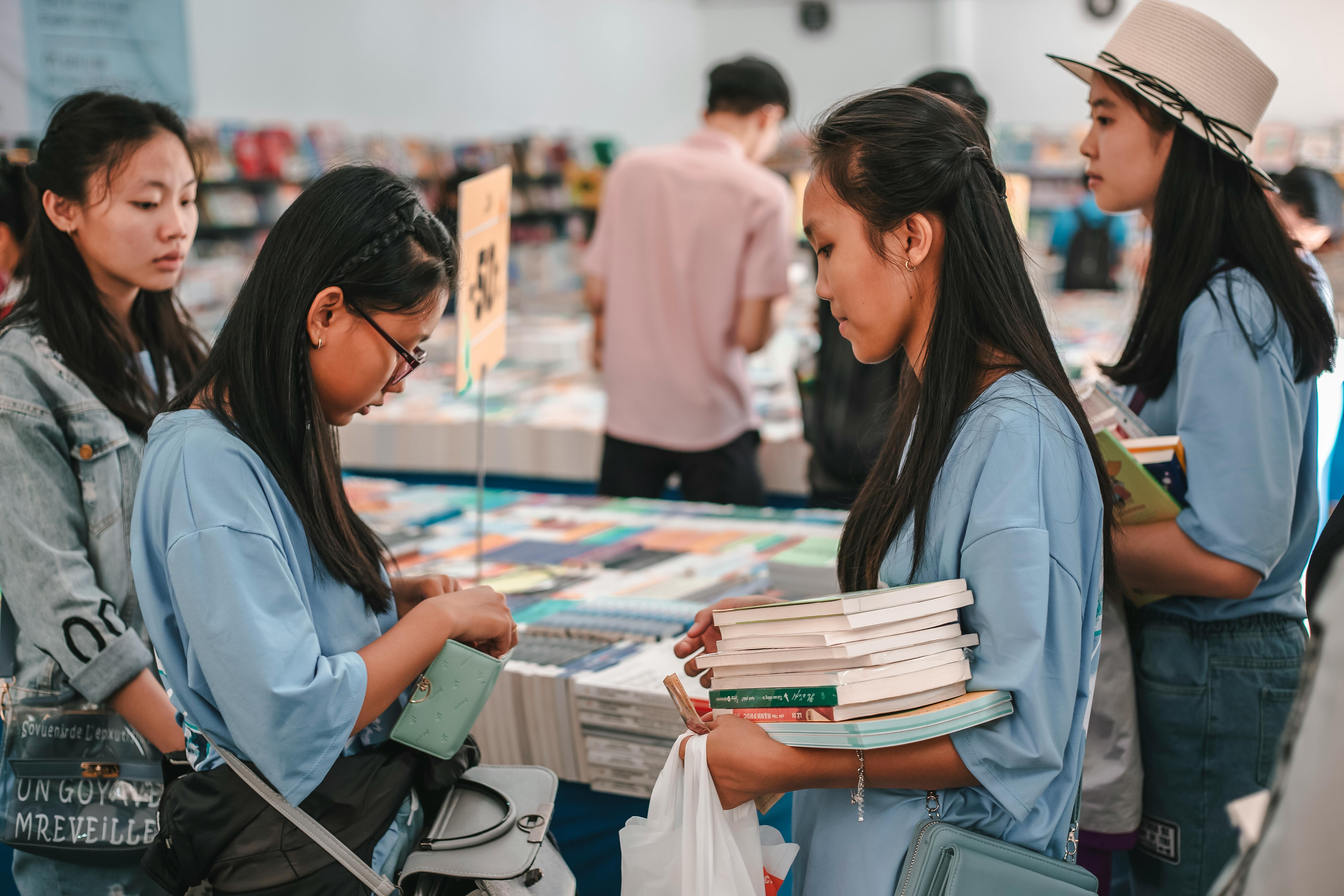 Planning study abroad from Thailand — Student backpack bookstore browsing.